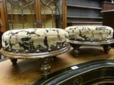 A PAIR OF CIRCULAR VINTAGE FOOTSTOOLS having upholstered tops with brass button edging on turned bun