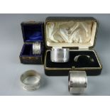 TWO CASED PAIRS OF HALLMARKED SILVER NAPKIN RINGS, a leaf chased pair, Birmingham 1902, 1.2 troy ozs