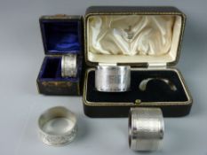 TWO CASED PAIRS OF HALLMARKED SILVER NAPKIN RINGS, a leaf chased pair, Birmingham 1902, 1.2 troy ozs