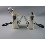 A PAIR OF SILVER CHOCOLATE POTS of plain tapered form with shaped ebony handles and knops to the