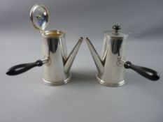 A PAIR OF SILVER CHOCOLATE POTS of plain tapered form with shaped ebony handles and knops to the