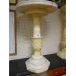 A CARVED ALABASTER CIRCULAR STAND, the 40 cms top on a pineapple column and stepped base, 61 cms