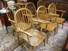 SIX ANTIQUE FARMHOUSE ARMCHAIRS having and hoop and spindle backs, turned arm and leg supports