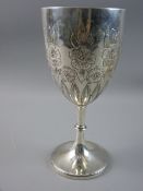 A HALLMARKED SILVER GOBLET having embossed floral and leaf decoration on a knopped pedestal with
