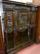 A CARVED CONTINENTAL HALL CABINET abundantly decorated with panels of mythological scenes on the top