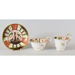 A NANTGARW 'JAPAN' PATTERN TRIO of cups and saucer decorated by Thomas Pardoe in the Imari palette