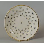 A NANTGARW PORCELAIN 'HENSOL CASTLE' PLATE decorated with blue berries with gilded leaves and with