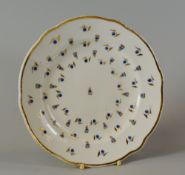 A NANTGARW PORCELAIN 'HENSOL CASTLE' PLATE decorated with blue berries with gilded leaves and with