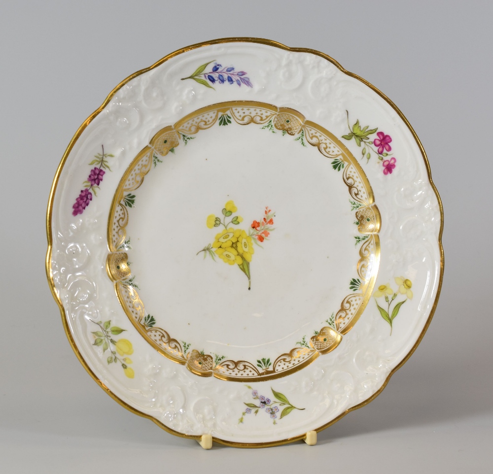 A SWANSEA PORCELAIN DESSERT PLATE with lobed rim and having a moulded border with C-scrolls,