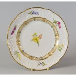 A SWANSEA PORCELAIN DESSERT PLATE with lobed rim and having a moulded border with C-scrolls,
