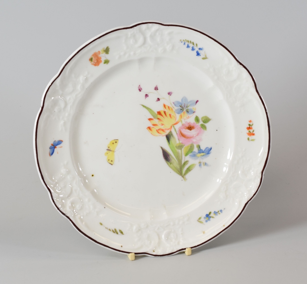 A NANTGARW PORCELAIN PLATE having a moulded and lobed border locally decorated with butterflies