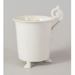 A SWANSEA PORCELAIN UNDECORATED CABINET CUP of cylindrical shape with everted rim and raised on