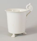 A SWANSEA PORCELAIN UNDECORATED CABINET CUP of cylindrical shape with everted rim and raised on