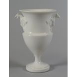 A SWANSEA PORCELAIN UNDECORATED URN VASE with twin eagle-form handles and having a flared rim and