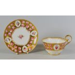 A NANTGARW PORCELAIN CUP & SAUCER decorated with pink roses and floral sprays to four cartouches and
