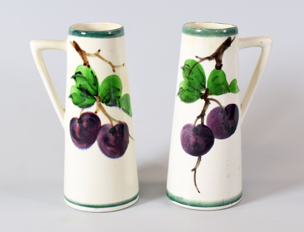 A PAIR OF LLANELLY SPILL-VASES each with single angular handle and painted with plums on vines,