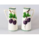 A PAIR OF LLANELLY SPILL-VASES each with single angular handle and painted with plums on vines,