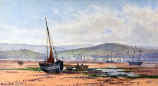 PETER GHENT watercolour - numerous beached boats and figures in an estuary with town and mountain