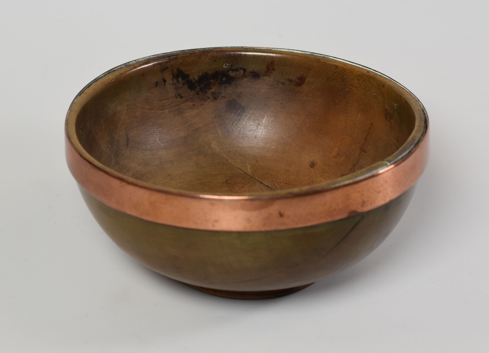 A WELSH SYCAMORE TREEN CAWL BOWL of simple footed form and having a copper reinforcement band, 17cms