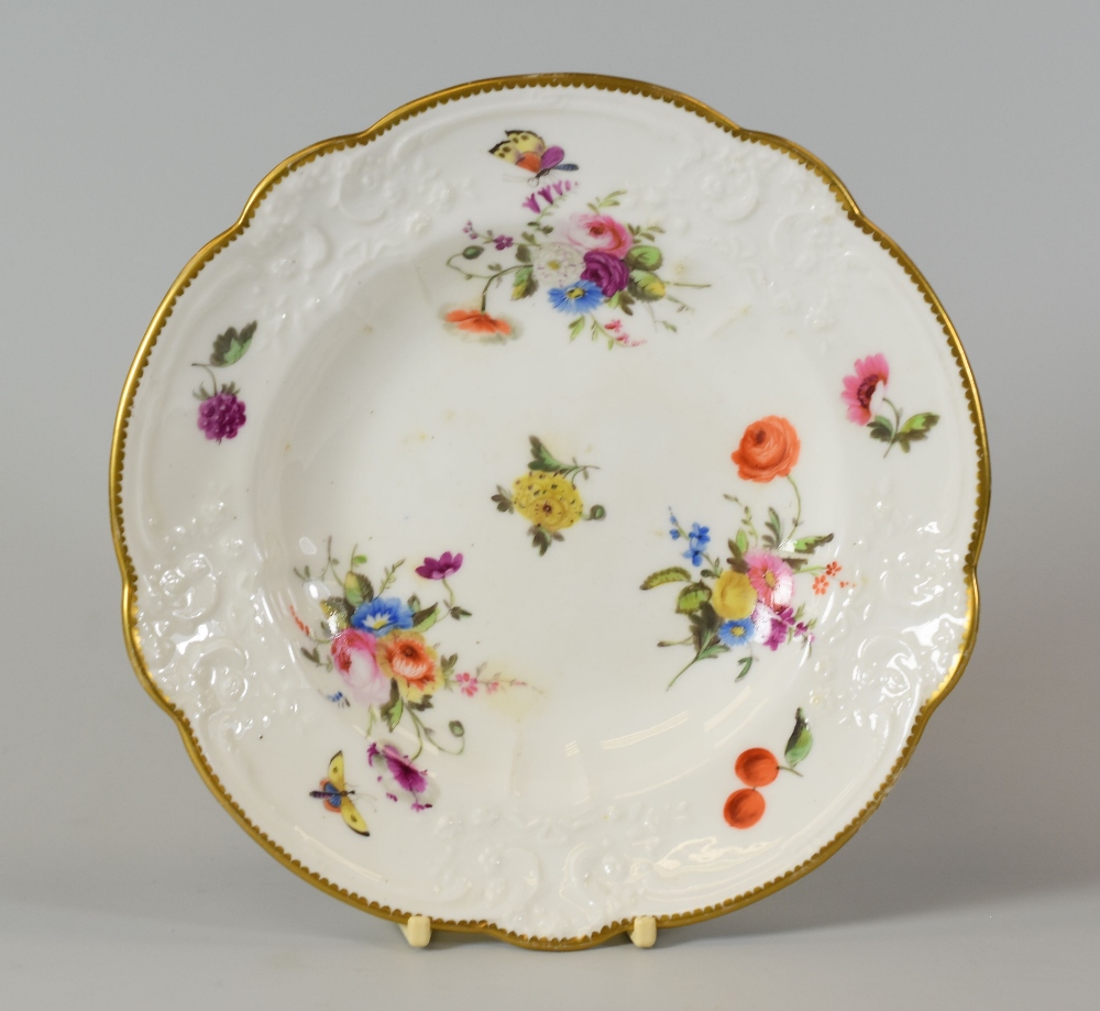 A NANTGARW SOUP PLATE having a moulded and alternate lobed border and painted with three large