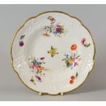A NANTGARW SOUP PLATE having a moulded and alternate lobed border and painted with three large