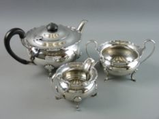 A THREE PIECE SILVER TEASET of teapot, sugar and milk jug, circular squat form with wavy edge top