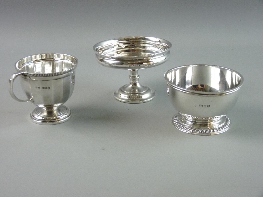 A SILVER CUP AND TWO FURTHER ITEMS, the segmented cup with reeded border on a circular foot,