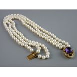 A TRIPLE NECKLACE OF UNIFORM NATURAL PEARLS having a nine carat oval clasp adorned with seed