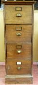 A POLISHED WOODEN FOUR DRAWER FILING CABINET, each drawer with a front label frame and brass handle