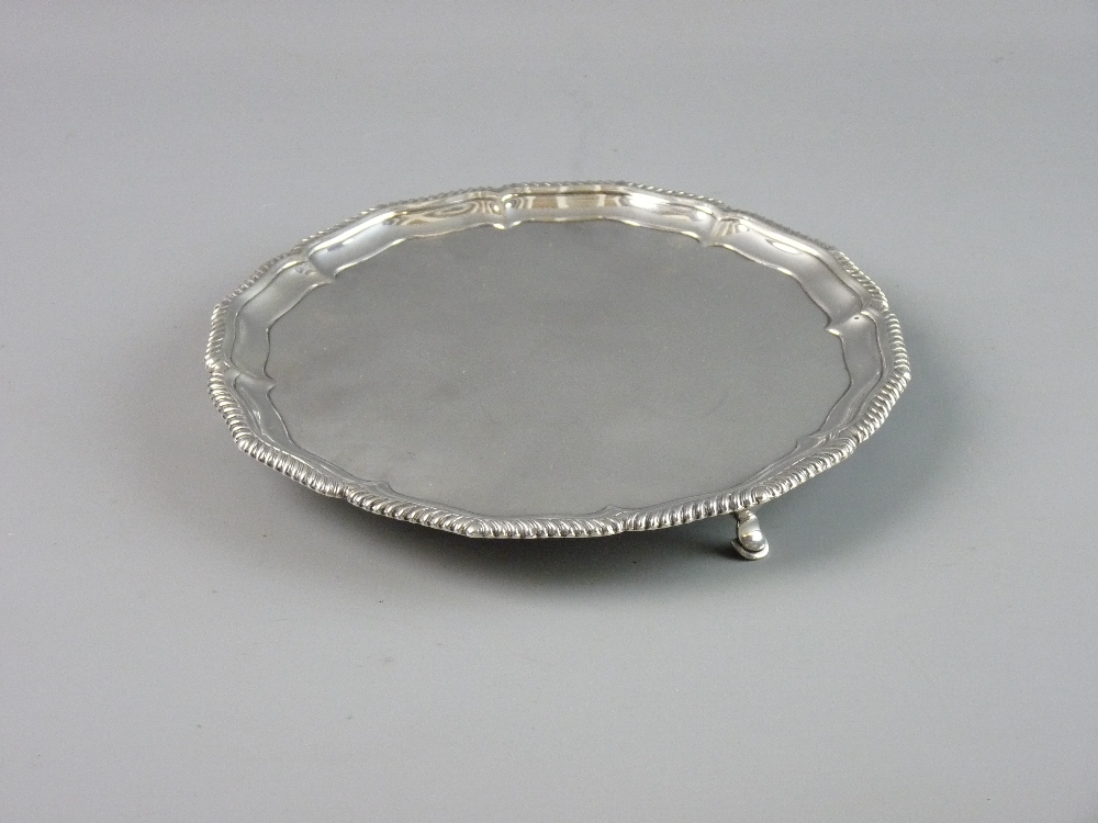 A SILVER THREE FOOTED CARD TRAY with wavy border and gadrooned edge, London 1905, 12.5 troy ozs,