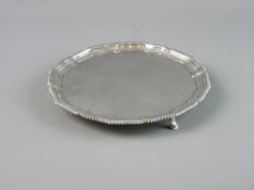 A SILVER THREE FOOTED CARD TRAY with wavy border and gadrooned edge, London 1905, 12.5 troy ozs,