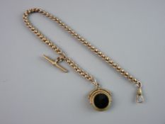 A NINE CARAT GOLD T-BAR with yellow metal swivel compass fob and yellow metal link Albert