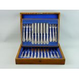 A WOODEN CANTEEN OF EARLY 20th CENTURY DESSERT/FRUIT KNIVES AND FORKS, twelve knives and twelve for