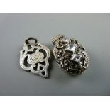 A SILVER TROPHY STYLE PENDANT, 4.2 grms and an oval white metal marcasite locket with three square