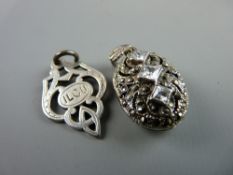A SILVER TROPHY STYLE PENDANT, 4.2 grms and an oval white metal marcasite locket with three square