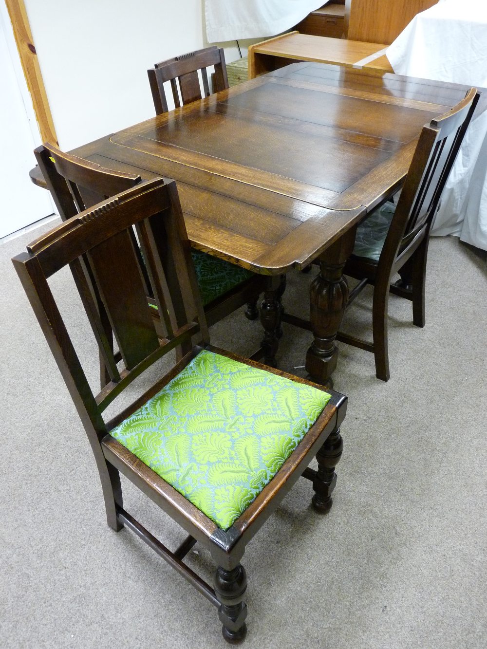 A 1930's POLISHED DRAW LEAF DINING TABLE with pineapple and block supports and four similar period