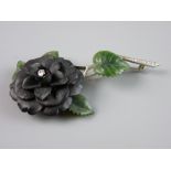 AN ATTRACTIVE FINE QUALITY WHITE METAL FLORAL BROOCH having a black bog oak style flower with