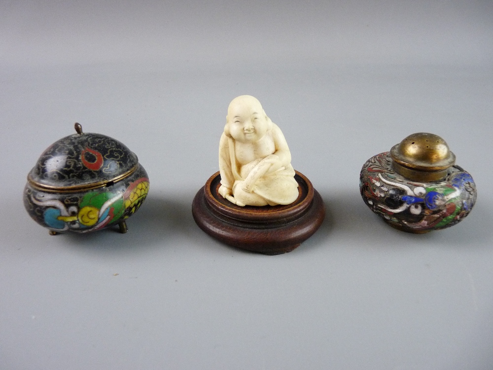 A JAPANESE IVORY NETSUKE of a seated figure and two miniature cloisonné containers, one an inkpot