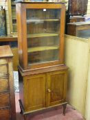 A VINTAGE BOOKCASE CUPBOARD, single glazed door mahogany top with interior shelves on a scumble