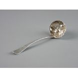 AN ORNATE SILVER SUGAR SIFTER, the bowl with raised fruit and leaf decoration and the handle with