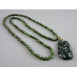 A DARK GREEN JADITE NECKLACE with monkey pendant, 74 cms long, 62 grms gross