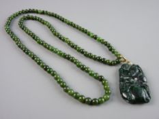 A DARK GREEN JADITE NECKLACE with monkey pendant, 74 cms long, 62 grms gross