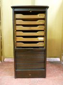 A POLISHED TAMBOUR FRONT CABINET having nine interior sliding trays