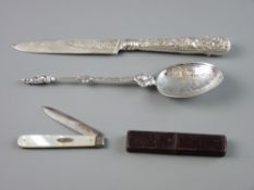 A DECORATIVE SILVER SPOON, the bowl depicting a female figure holding scales and a sword and with