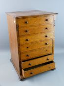 AN OAK COLLECTOR'S CHEST of seven drawers having turned wooden knobs and squat bun feet, 48 cms