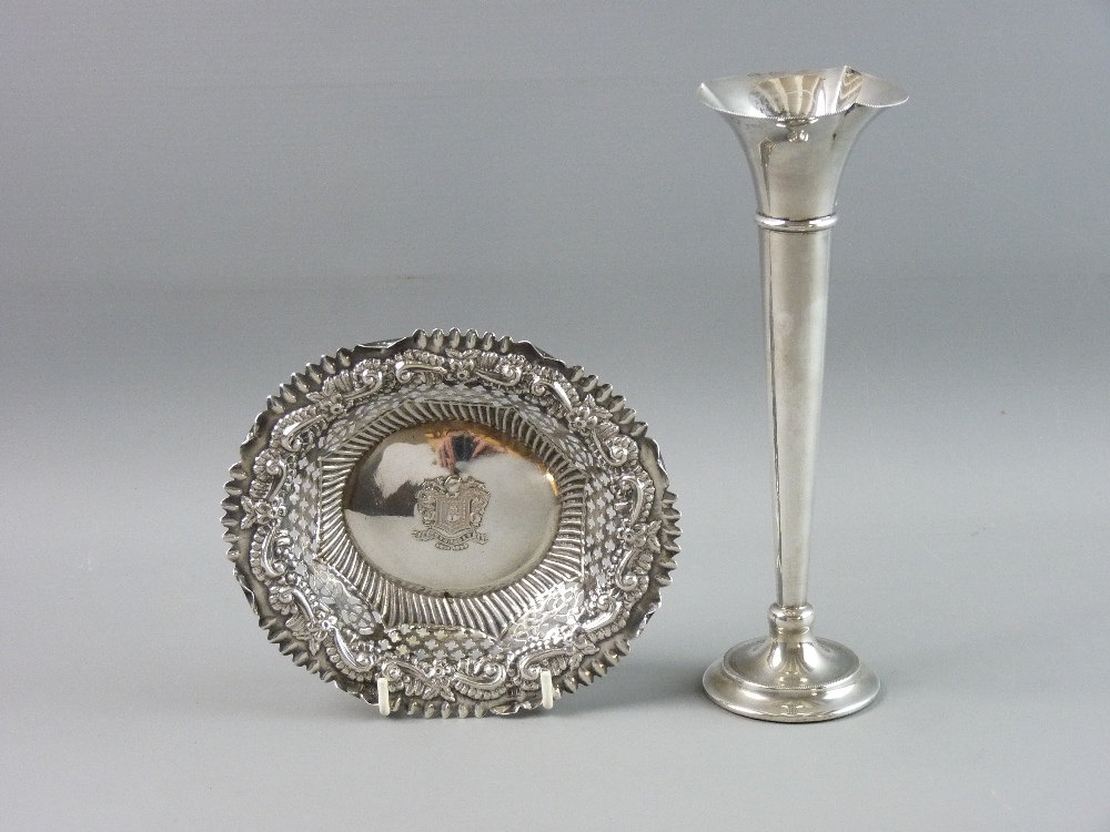 AN OVAL SILVER DISH heavily scrolled, pierced and decorated and with coat of arms to the base, 2.8