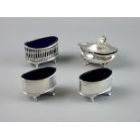 A GROUP OF SILVER SALTS to include a lidded example on four feet, a pierced oval on four feet,