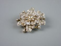 A BELIEVED GOLD MOUNTED CIRCULAR PENDANT BROOCH in the form of diamond encrusted leaves and
