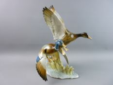 A GERMAN PORCELAIN PAIR OF DUCKS IN FLIGHT by Hutschenreuther with original potter's label to the