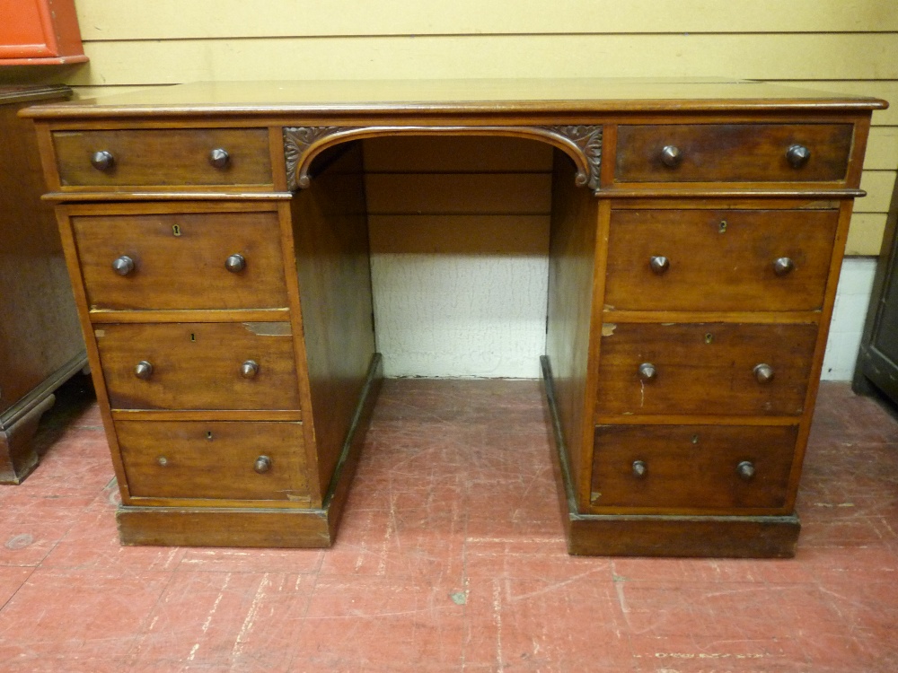 A VICTORIAN MAHOGANY KNEEHOLE WRITING DESK, each pedestal having a narrow top drawer with three
